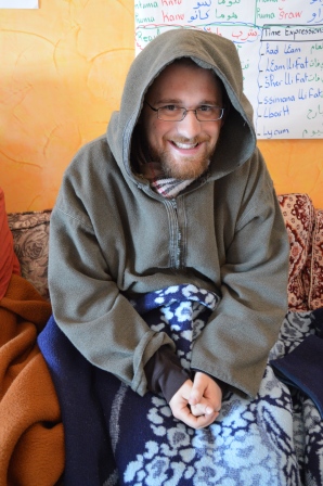 Here is Matthew trying to keep warm in his jellaba and blanket.